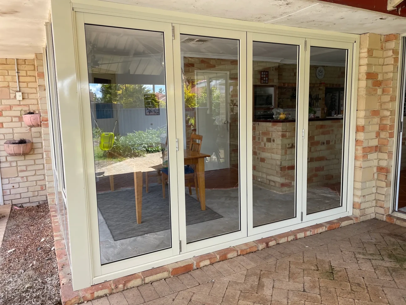 White acoustics and weather sealing bi-fold doors